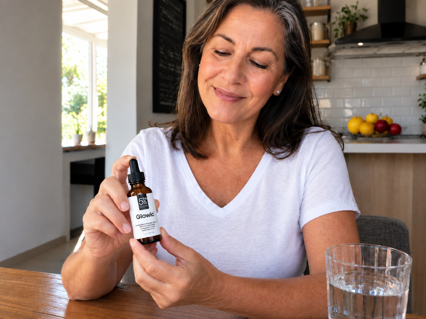 Woman showing Glowic serum in her kitchen